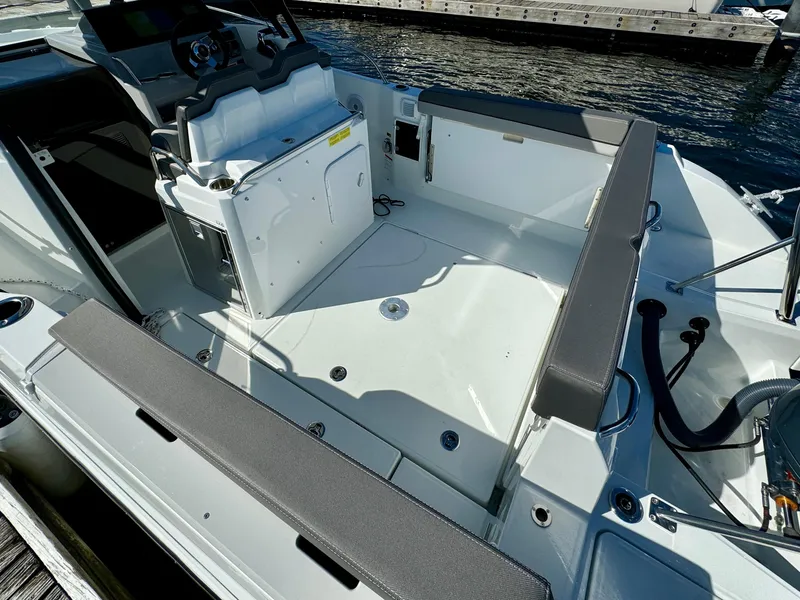 Slide: The Image of 2024 Jeanneau Leader 7.5 WA boat interior with seating and steering console. - 11