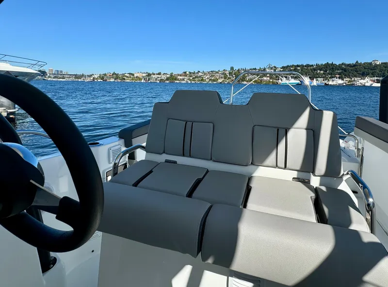 Slide: The Image of 2024 Jeanneau Leader 7.5 WA boat interior with comfortable seating on a sunny day. - 15