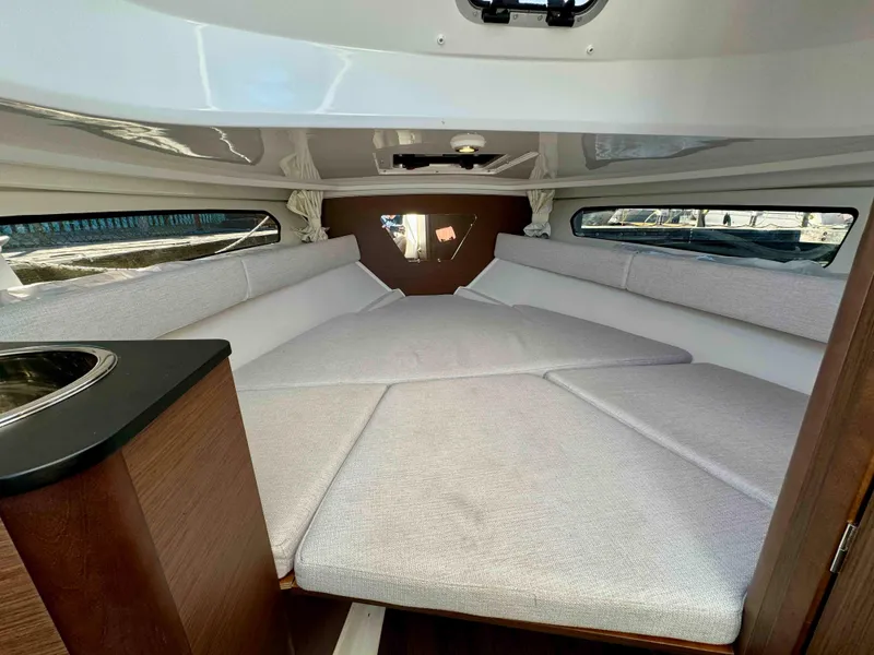 Slide: The Image of 2024 Jeanneau Leader 7.5 WA cabin interior with cozy seating and modern design. - 17