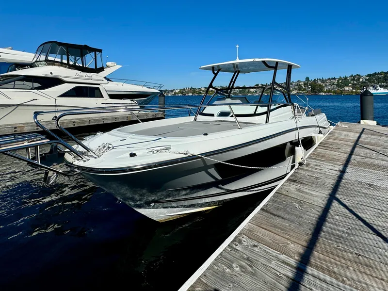 Slide: The Image of 2024 Jeanneau Leader 7.5 WA boat docked at a marina under clear blue skies. - 3