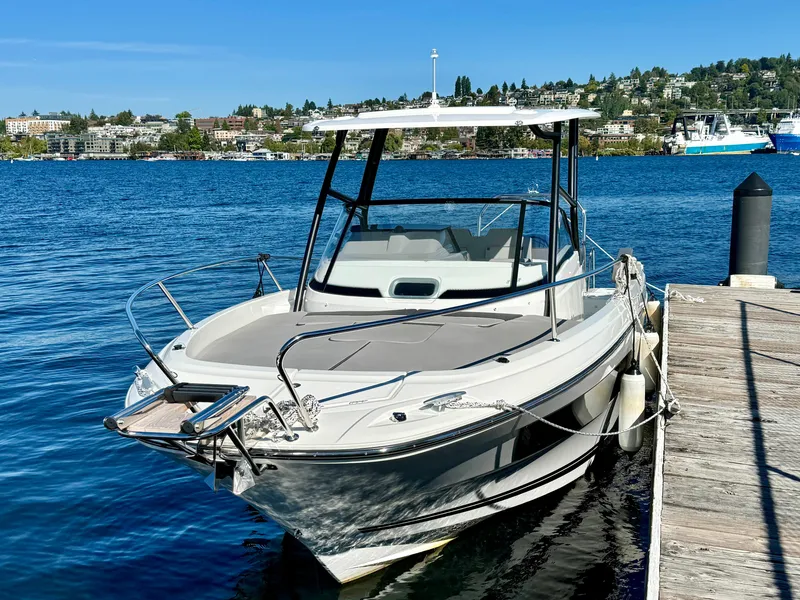 Slide: The Image of 2024 Jeanneau Leader 7.5 WA boat docked by a scenic waterfront. - 5