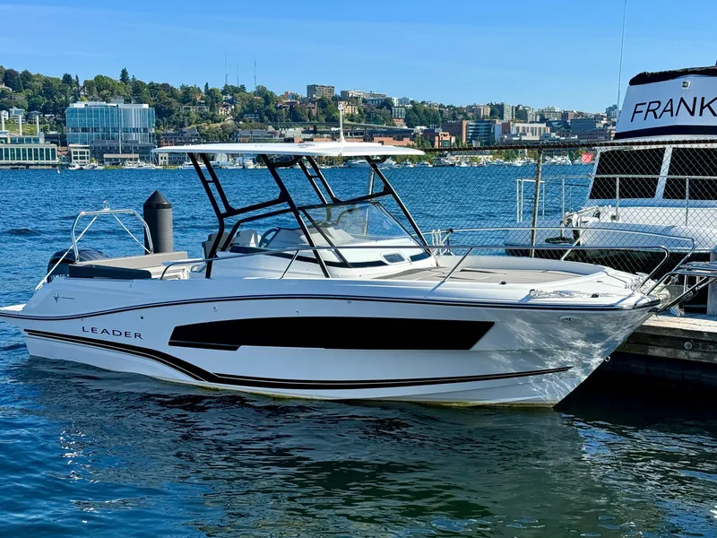 Slide: The Image of 2024 Jeanneau Leader 7.5 WA boat docked on a sunny waterfront. - 7
