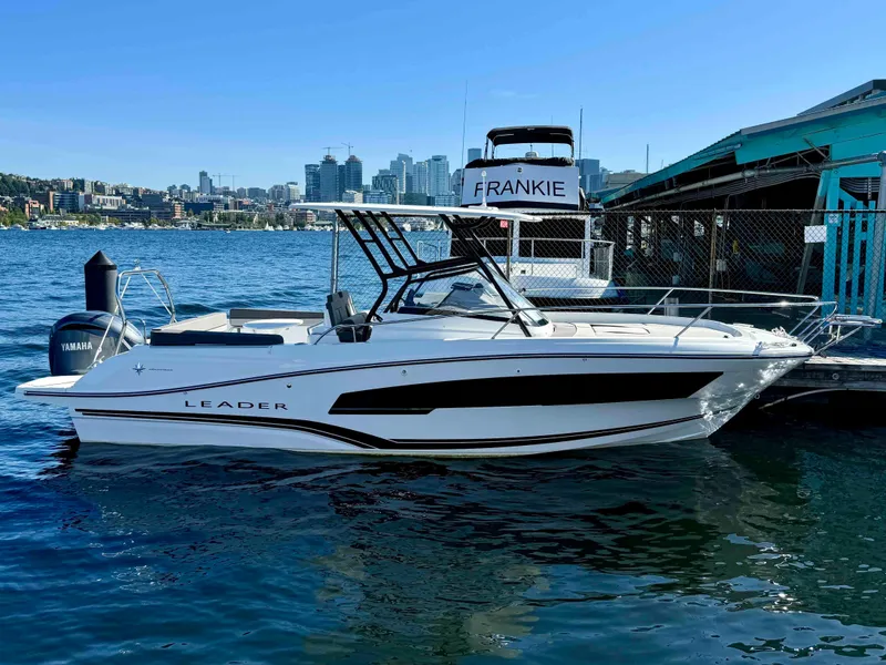 Slide: The Image of 2024 Jeanneau Leader 7.5 WA boat docked by the waterfront with city skyline. - 8