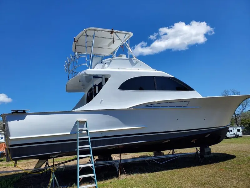 Slide: The Image of 2005 Custom Carolina C 30 CAT boat on land, clear sky background. - 0
