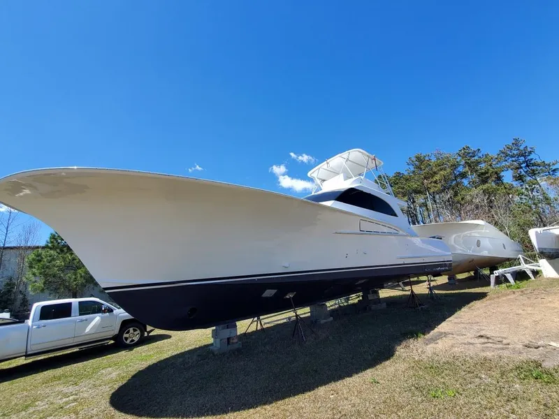 Slide: The Image of 2005 Custom Carolina C 30 CAT boat on land, clear sky background. - 1