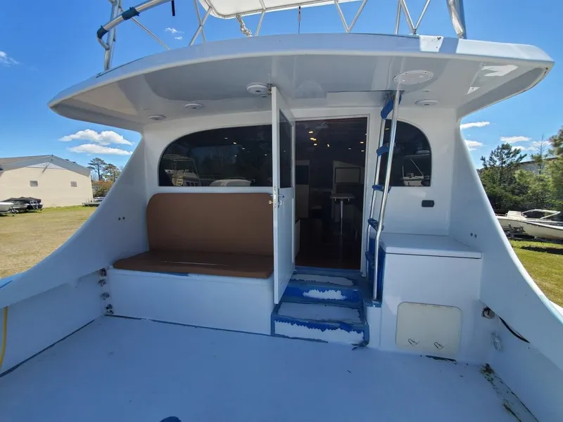 Slide: The Image of 2005 Custom Carolina C 30 CAT boat with open deck and seating area. - 13