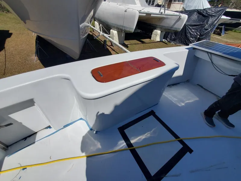 Slide: The Image of 2005 Custom Carolina C 30 CAT boat deck with storage compartment and clean white finish. - 15