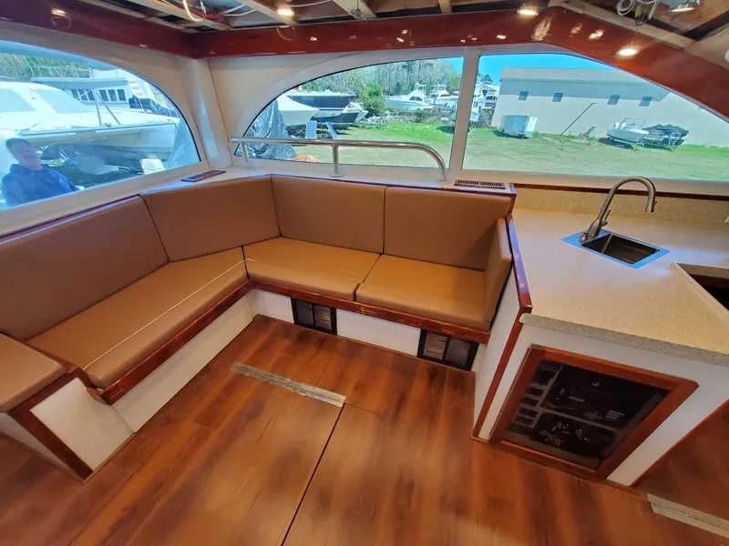 Slide: The Image of 2005 Custom Carolina C 30 CAT interior with wood flooring and beige seating. - 17