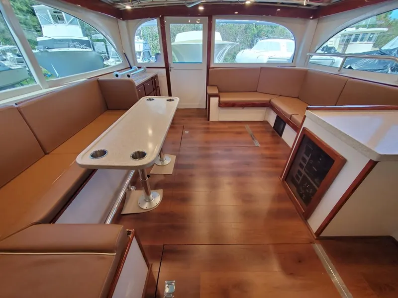 Slide: The Image of Luxurious interior of 2005 Custom Carolina C 30 CAT yacht with wood flooring and seating. - 18