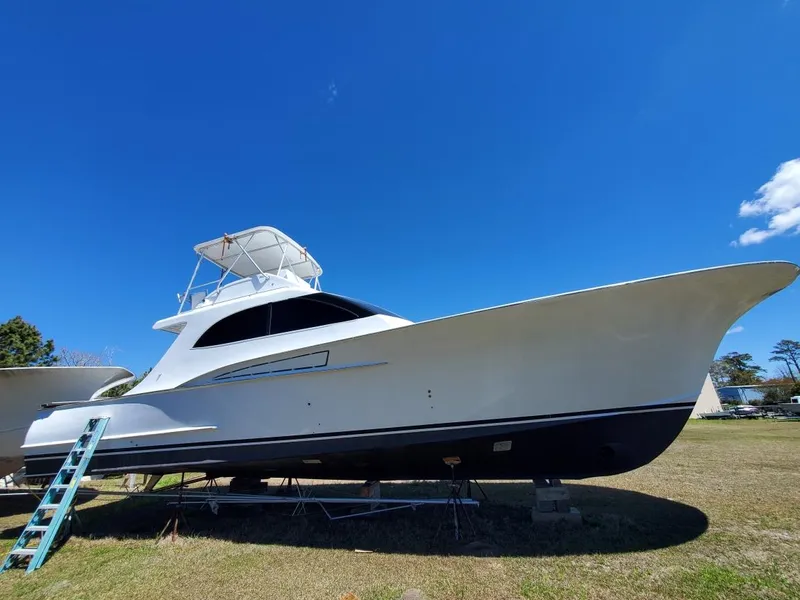 Slide: The Image of 2005 Custom Carolina C 30 CAT boat on land under clear blue sky. - 2