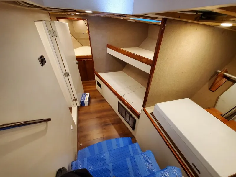 Slide: The Image of Interior of 2005 Custom Carolina C 30 CAT boat with wooden flooring and bunk beds. - 22