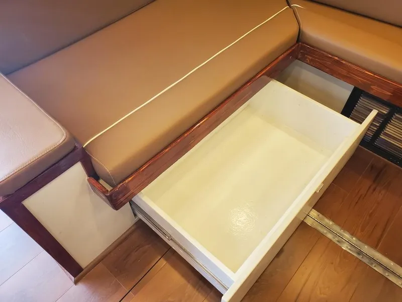 Slide: The Image of Open drawer under brown cushioned seating on 2005 Custom Carolina C 30 CAT boat. - 24