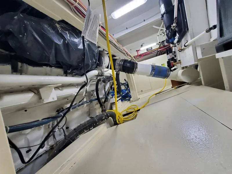 Slide: The Image of Engine room of 2005 Custom Carolina C 30 CAT boat, featuring cables and pipes. - 25
