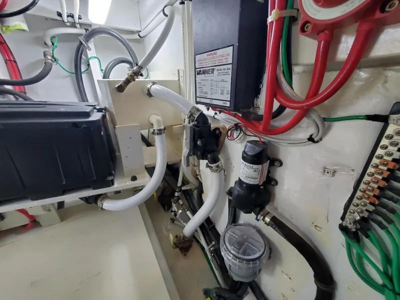Slide: The Image of Engine room of 2005 Custom Carolina C 30 CAT with wiring and plumbing components. - 26