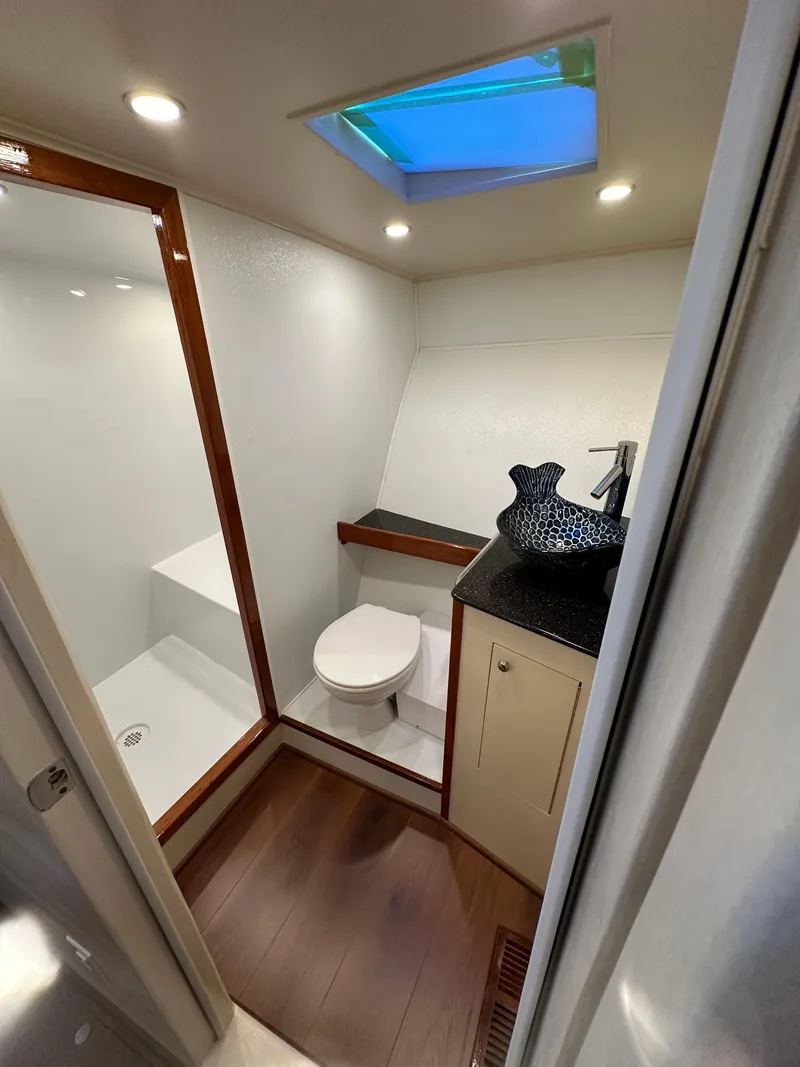 Slide: The Image of Luxurious 2005 Custom Carolina C 30 CAT yacht bathroom with modern fixtures and skylight. - 30