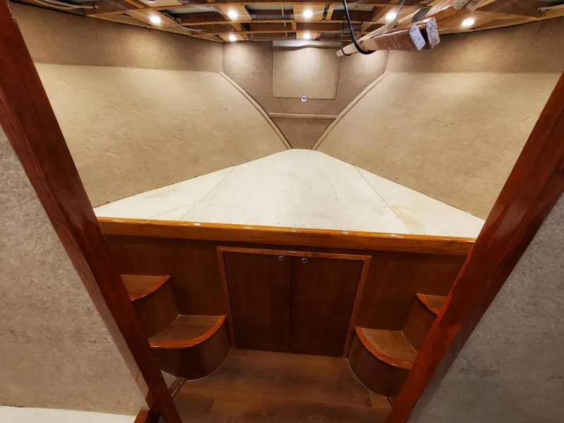 Slide: The Image of Interior of 2005 Custom Carolina C 30 CAT boat with wooden finishes and recessed lighting. - 31