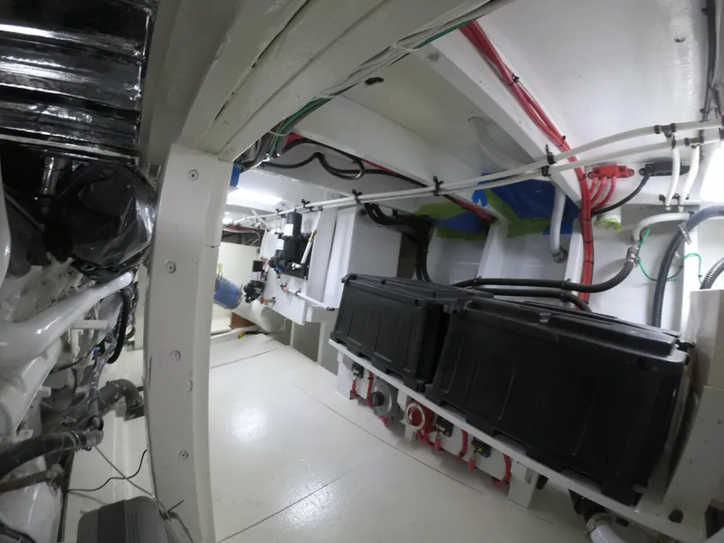 Slide: The Image of Engine room of 2005 Custom Carolina C 30 CAT with visible wiring and equipment. - 5