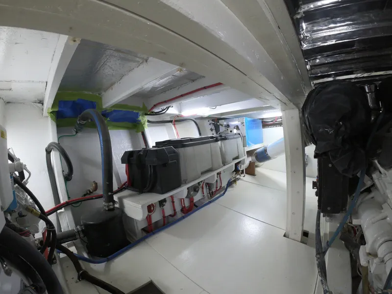 Slide: The Image of Engine room of 2005 Custom Carolina C 30 CAT boat, showcasing mechanical components and wiring. - 7
