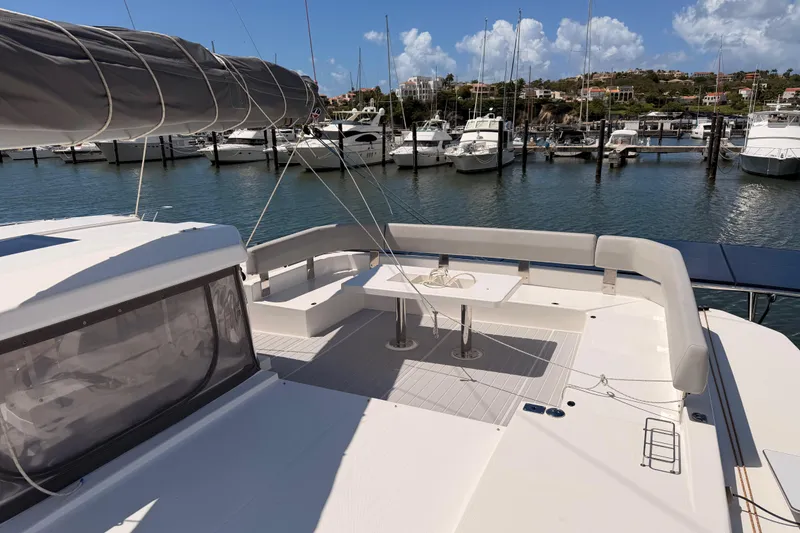 Slide: The Image of Leopard 50 catamaran, 2023 model, docked in a marina with clear skies and calm waters. - 10