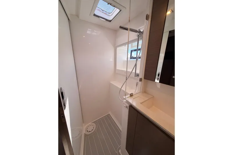 Slide: The Image of Modern shower area in 2023 Leopard 50 yacht with sleek design and skylight. - 16