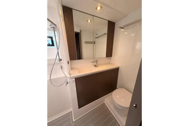 Slide: The Image of Modern yacht bathroom with sleek fixtures, mirror cabinet, and shower in Leopard 50, 2023 model. - 17