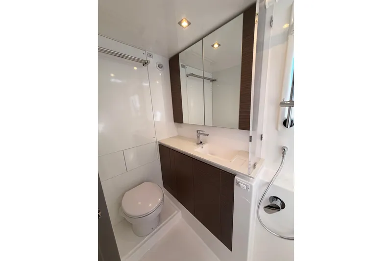 Slide: The Image of Modern yacht bathroom with sleek fixtures, mirror cabinets, and shower in Leopard 50, 2023 model. - 18
