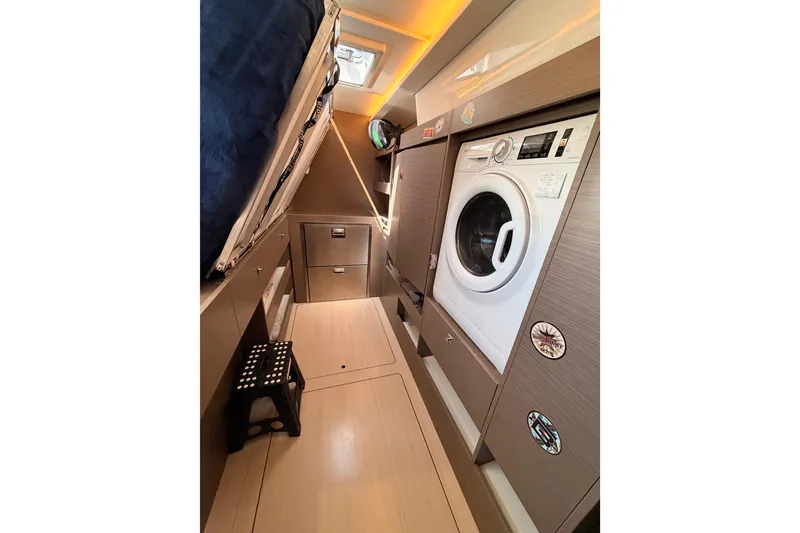 Slide: The Image of Laundry area inside 2023 Leopard 50 yacht, featuring a modern washing machine. - 21