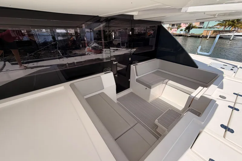 Slide: The Image of Modern Leopard 50 yacht interior, 2023 model, featuring sleek seating and waterfront view. - 32