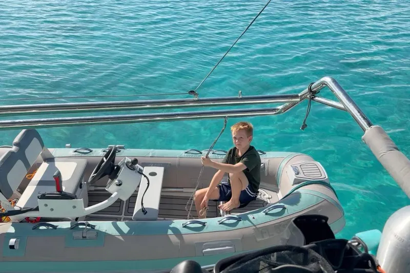 Slide: The Image of Young boy on a Leopard 50 boat in clear turquoise water, 2023. - 35