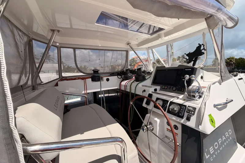 Slide: The Image of Interior view of 2023 Leopard 50 catamaran cockpit with steering wheel and navigation controls. - 5