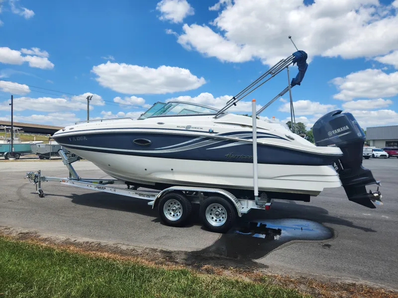 Slide: The Image of 2013 Hurricane SunDeck 2200 OB boat on a trailer under a blue sky. - 1