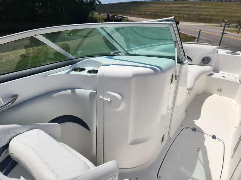 Slide: The Image of 2013 Hurricane SunDeck 2200 OB boat interior with white seating and windshield. - 10