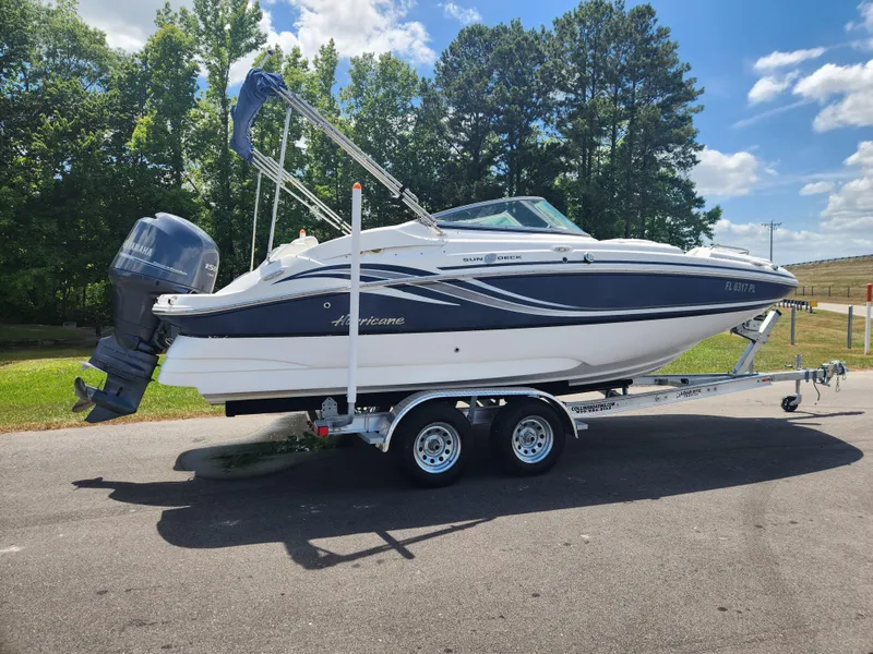 Slide: The Image of 2013 Hurricane SunDeck 2200 OB boat on a trailer, parked outdoors. - 3