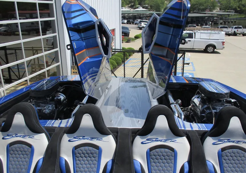 Slide: The Image of Skater 46 boat, 2002 model, with open engine hatches and custom seats in a marina. - 11