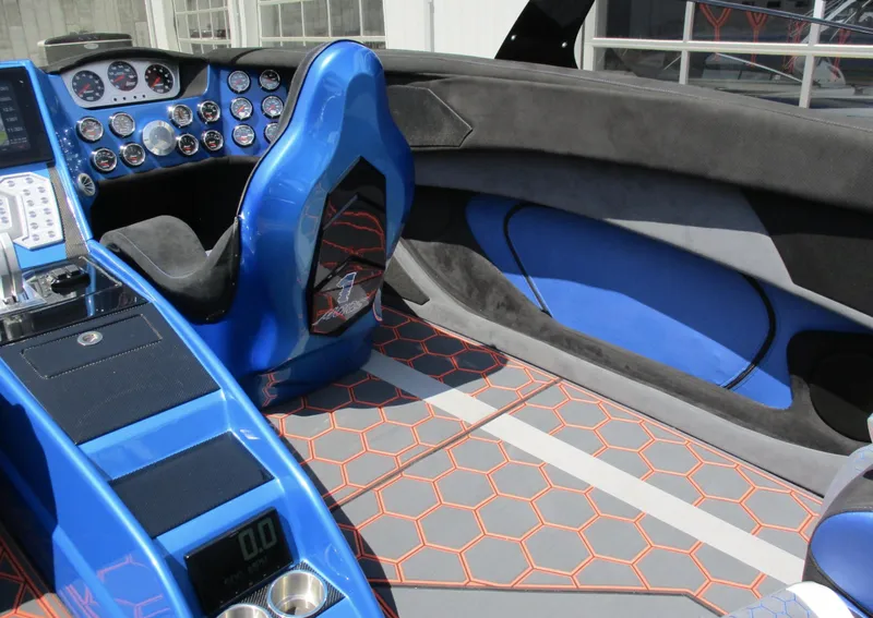 Slide: The Image of Interior of a 2002 Skater 46 boat with blue and black seats, hexagonal floor pattern. - 4
