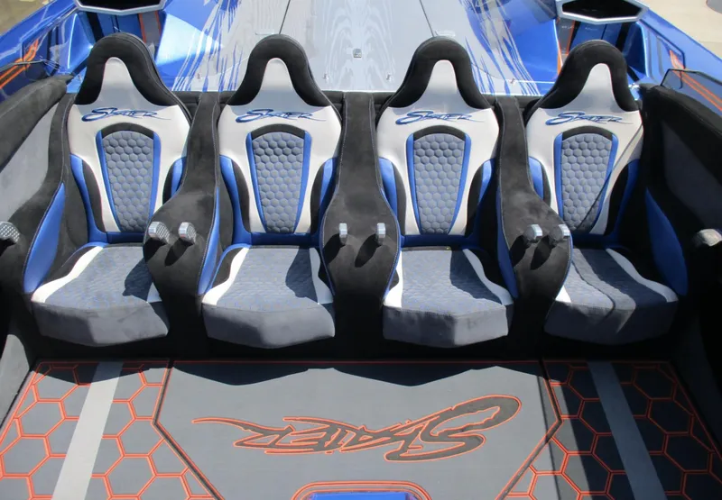 Slide: The Image of Four racing seats in a 2002 Skater 46 boat with blue and gray upholstery. - 7