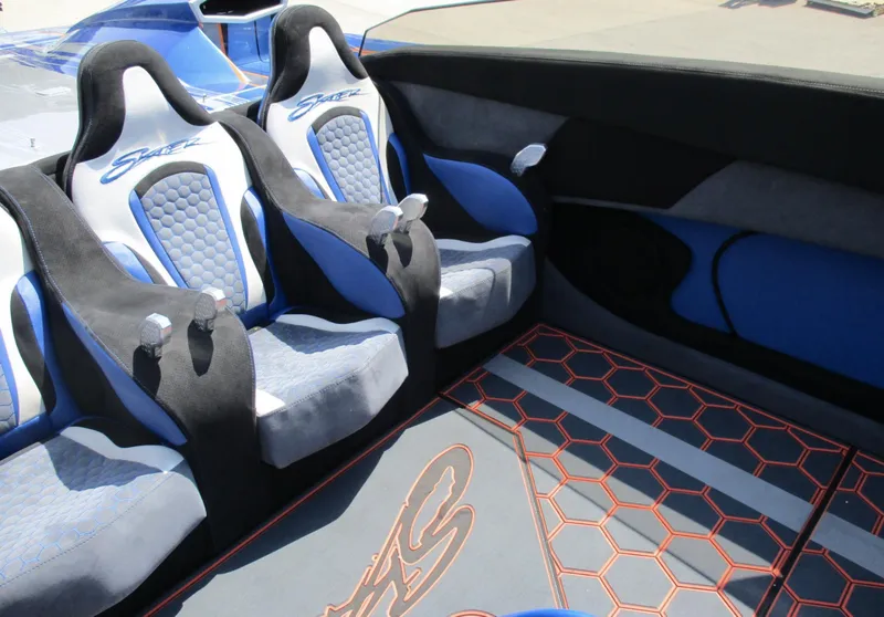 Slide: The Image of Interior of a 2002 Skater 46 boat with blue and gray seats. - 8