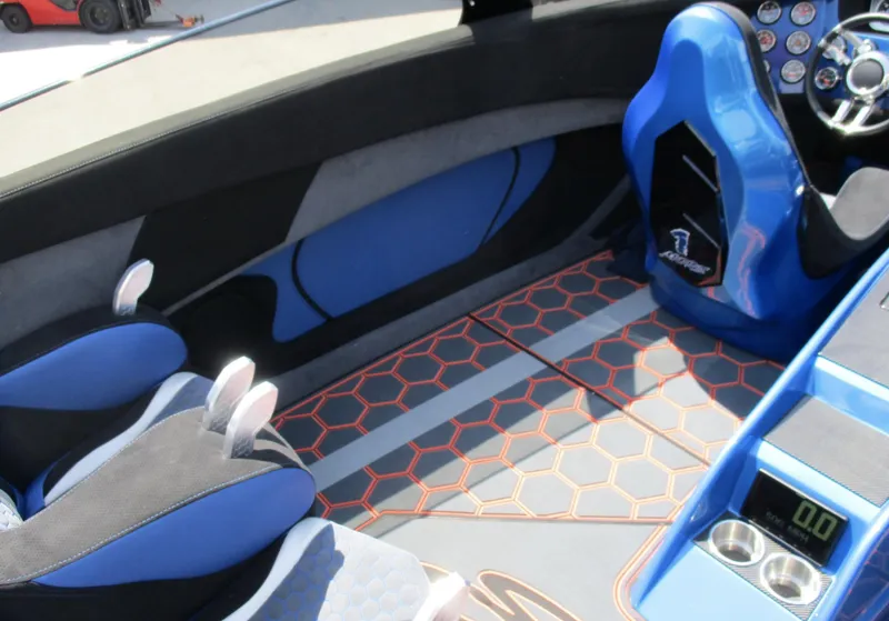 Slide: The Image of Interior of a 2002 Skater 46 boat with blue and black seats and hexagonal floor design. - 9