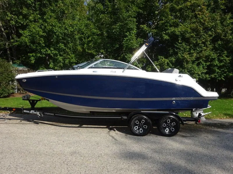 Slide: The Image of 2023 Four Winns HD3 boat on a trailer, parked outdoors. - 0