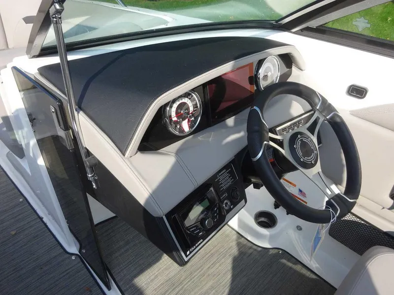 Slide: The Image of 2023 Four Winns HD3 boat dashboard with steering wheel and control panel. - 11