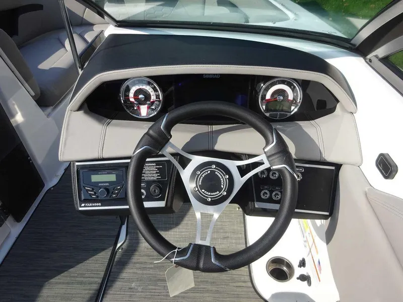 Slide: The Image of 2023 Four Winns HD3 boat dashboard with steering wheel and instrument panel. - 12