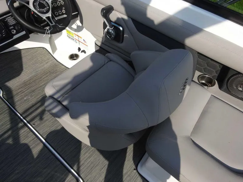 Slide: The Image of 2023 Four Winns HD3 boat interior with gray captain's chair and control panel. - 16