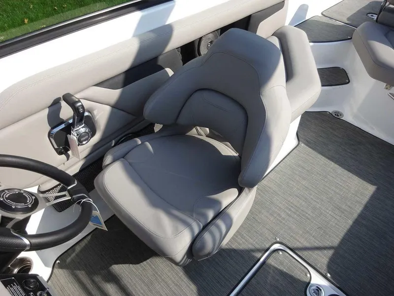Slide: The Image of 2023 Four Winns HD3 boat interior with gray captain's chair and steering wheel. - 17