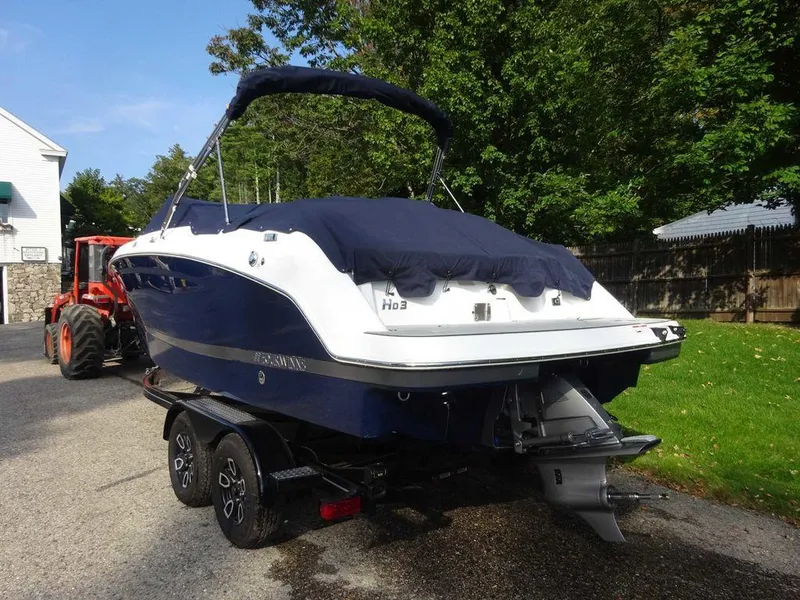 Slide: The Image of 2023 Four Winns HD3 boat on trailer, covered and parked outdoors. - 21
