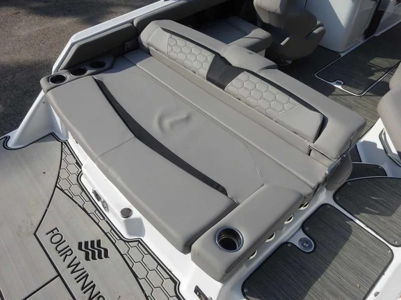 Slide: The Image of 2023 Four Winns HD3 boat with gray seating and cup holders. - 24
