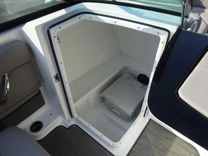 Slide: The Image of 2023 Four Winns HD3 boat interior storage compartment with portable toilet. - 5