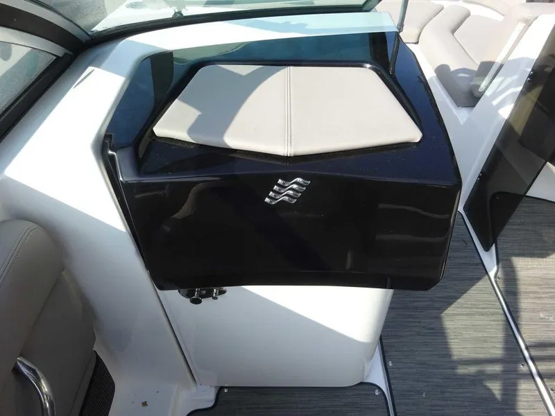 Slide: The Image of 2023 Four Winns HD3 boat interior with cushioned seating and sleek black console. - 9