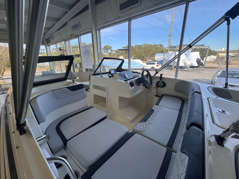 Slide: The Image of 2023 Bayliner Element M17 boat interior with modern seating and steering console. - 2