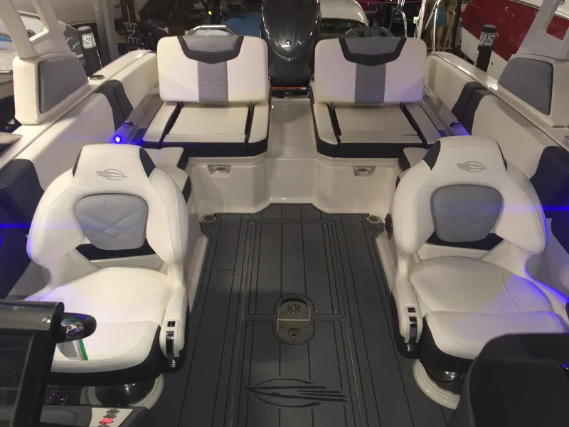 Slide: The Image of 2023 Chaparral 250 OSX boat interior with white and gray seating arrangement. - 10