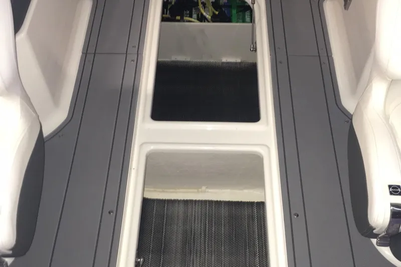 Slide: The Image of Interior view of 2023 Chaparral 250 OSX boat, featuring sleek seating and flooring. - 11